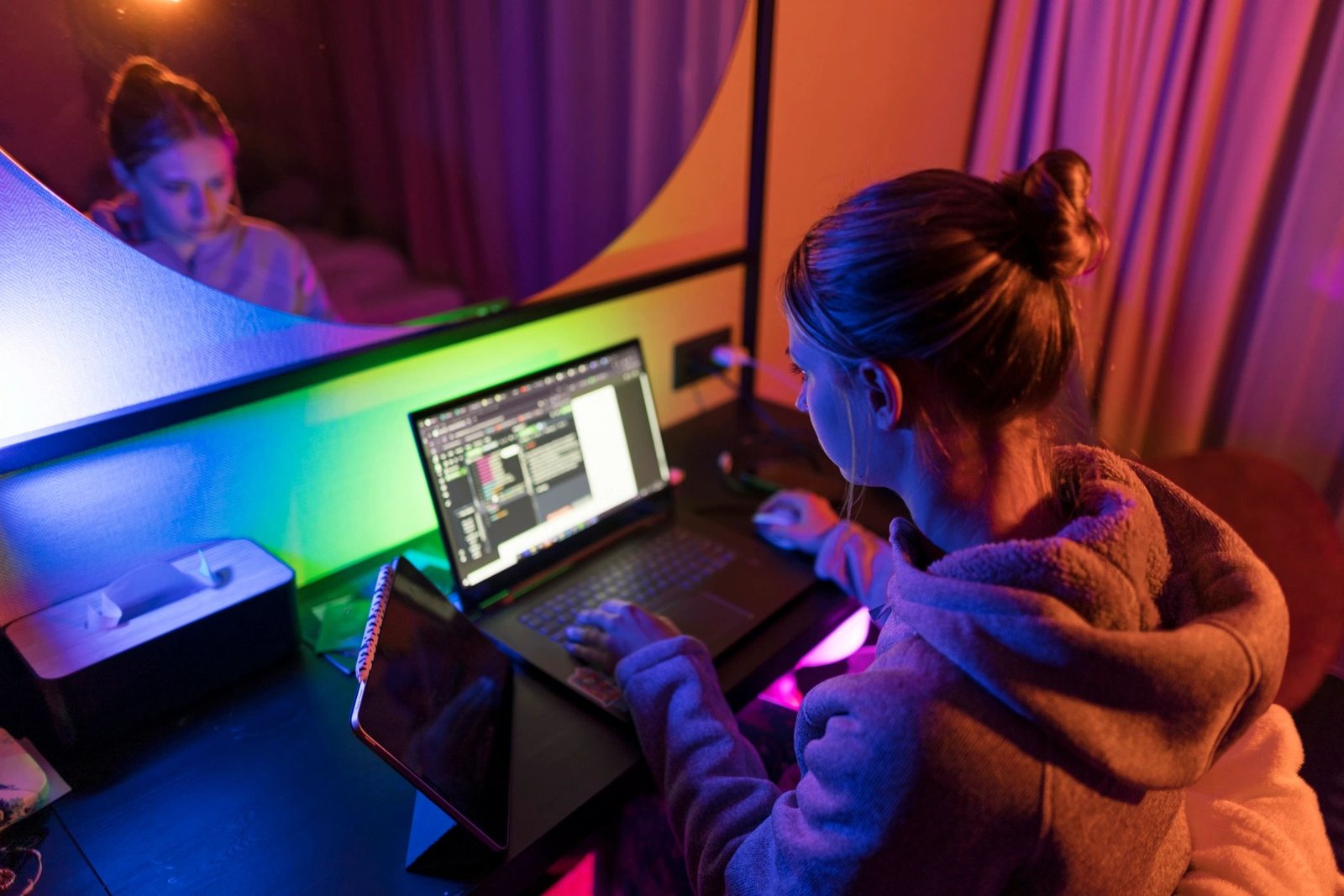 Developer focused on writing code on a laptop